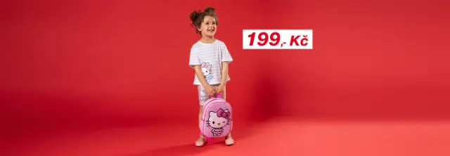 Dítě stojí před červeným pozadím, má na sobě pruhované tričko a kraťasy s motivem Hello Kitty a drží růžový batoh Hello Kitty
